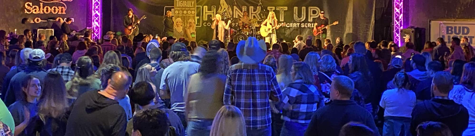 country concert with fans wearing cowboy hats Rochester