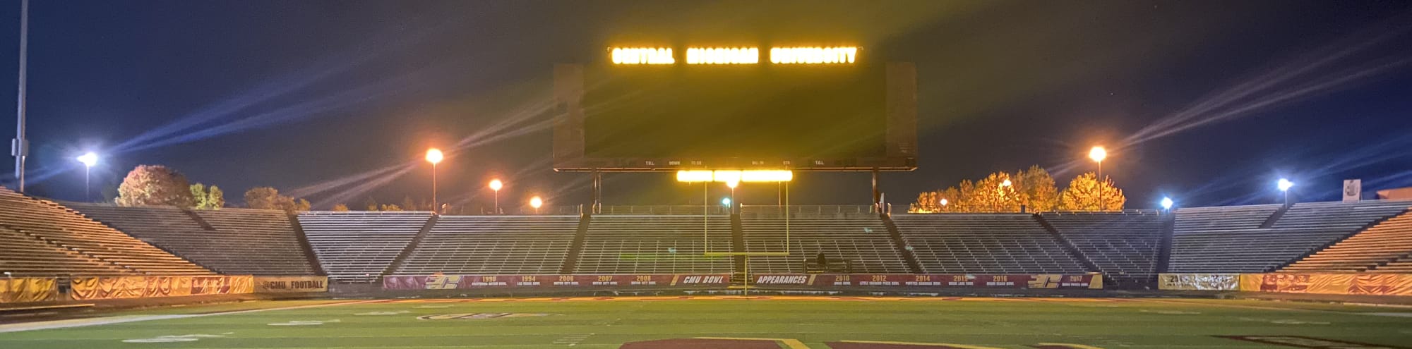 empty football stadium at night under the lights Rochester